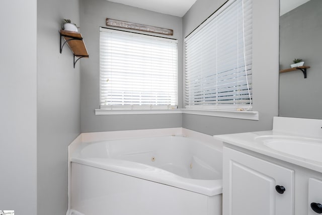 bathroom featuring vanity and a tub with jets