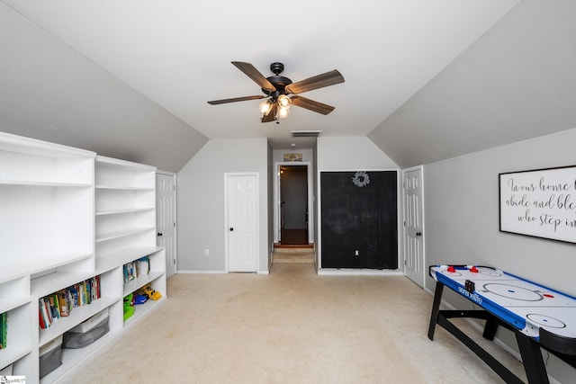 recreation room with lofted ceiling, visible vents, a ceiling fan, baseboards, and light colored carpet