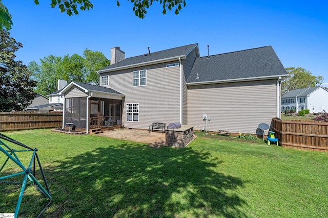 back of property with roof with shingles, a fenced backyard, a patio area, a lawn, and a sunroom