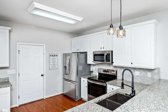 kitchen with white cabinets, appliances with stainless steel finishes, and a sink