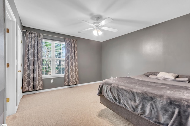 bedroom with carpet flooring, baseboards, and ceiling fan