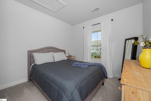 bedroom with visible vents, baseboards, carpet flooring, and attic access