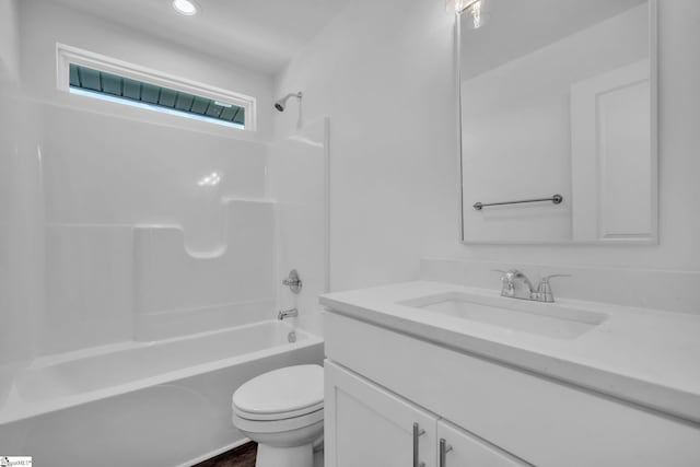 bathroom featuring toilet, vanity, and bathing tub / shower combination