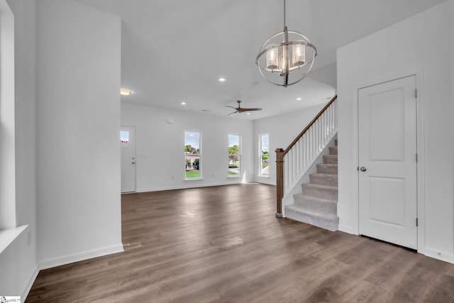 foyer entrance featuring ceiling fan with notable chandelier, wood finished floors, recessed lighting, and stairs