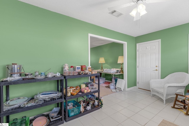 recreation room featuring visible vents, tile patterned floors, and ceiling fan