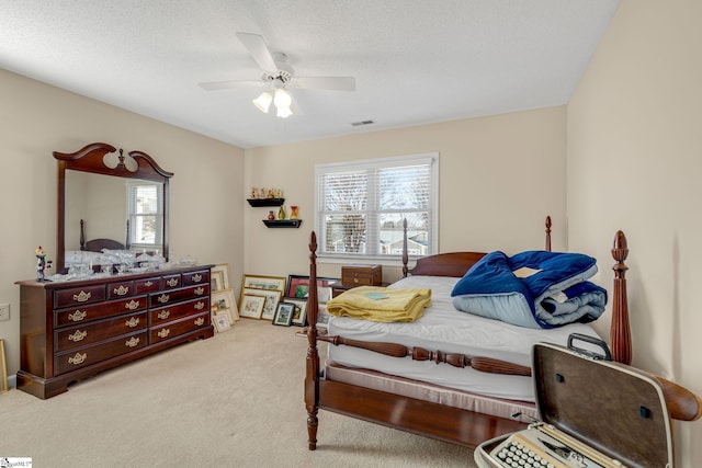 bedroom with carpet floors, visible vents, and a ceiling fan
