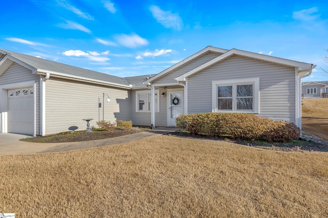ranch-style home with concrete driveway, a front yard, and a garage