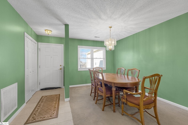 dining space with baseboards, visible vents, and a notable chandelier