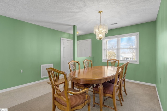 dining area with baseboards, a chandelier, and visible vents