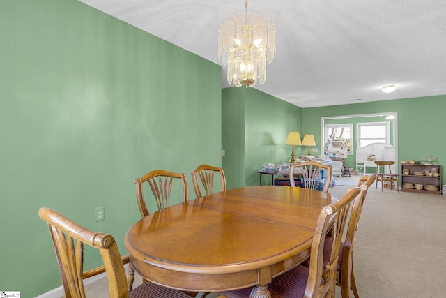 dining space featuring carpet flooring, a textured ceiling, and a notable chandelier