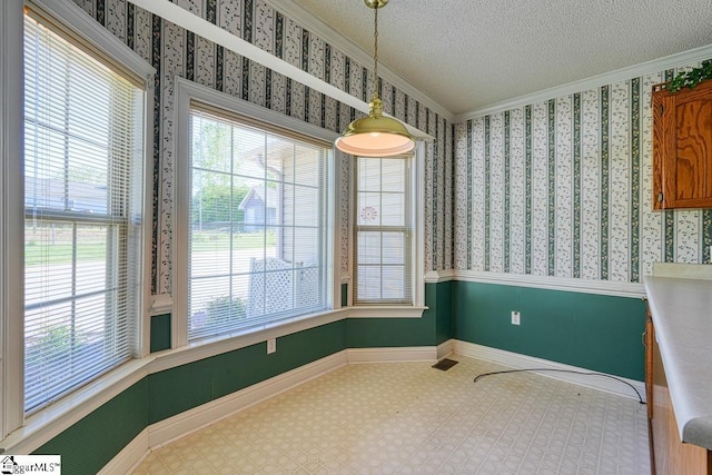 125 N River Hills Dr, Spartanburg, SC 29303 - unfurnished dining area featuring plenty of natural light, baseboards, a textured ceiling, and crown molding