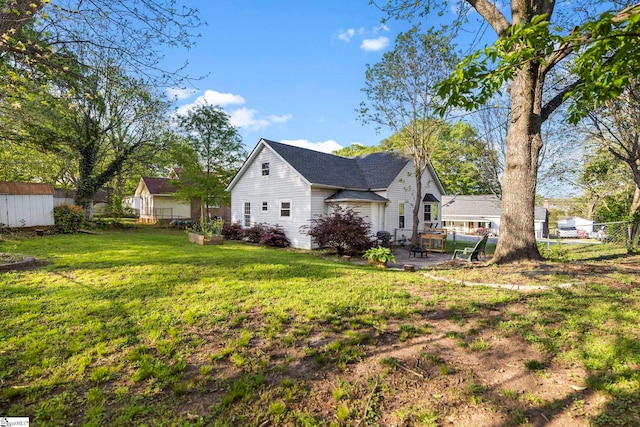 408 S 2nd St, Easley, SC 29640 - view of side of home with a patio area, a lawn, a shingled roof, and fence