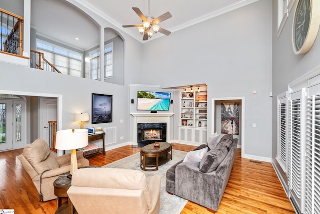 127 Warren Dr, Easley, SC 29640 - living room featuring baseboards, a ceiling fan, wood finished floors, a high ceiling, and ornamental molding