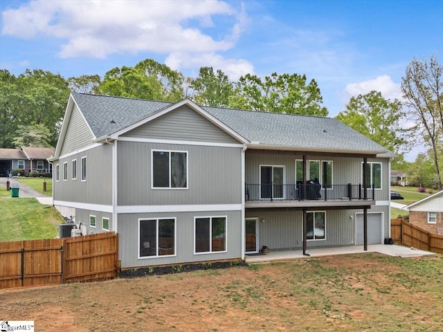 308 Pineridge Dr, Spartanburg, SC 29303 - back of property featuring a fenced backyard, central AC, an attached garage, a patio, and a lawn