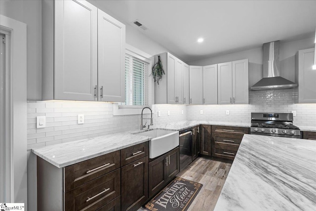 308 Pineridge Dr, Spartanburg, SC 29303 - kitchen with wall chimney range hood, light stone counters, tasteful backsplash, a sink, and appliances with stainless steel finishes