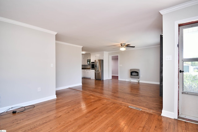 105 Ridgeland Cir, Easley, SC 29640 - unfurnished living room with baseboards, heating unit, wood finished floors, a ceiling fan, and ornamental molding