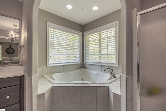 full bathroom featuring a whirlpool tub, recessed lighting, and vanity