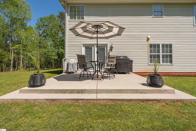 back of house with a yard and a patio area