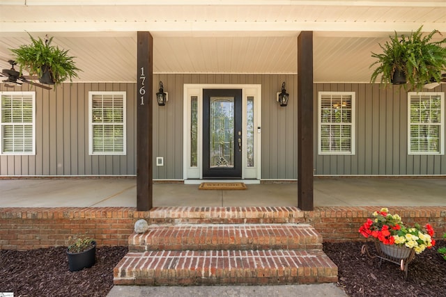 property entrance featuring board and batten siding and covered porch