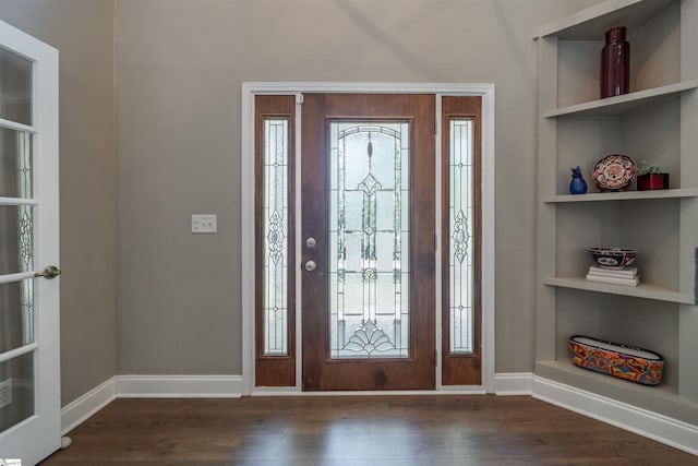 entrance foyer featuring baseboards, dark wood-style floors, and plenty of natural light