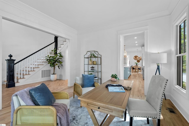 home office featuring baseboards, crown molding, visible vents, and an inviting chandelier