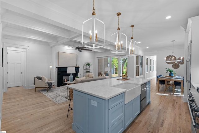 kitchen featuring a breakfast bar area, a lit fireplace, light wood-style flooring, coffered ceiling, and beam ceiling