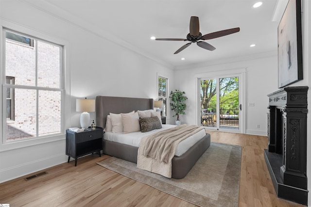 bedroom featuring visible vents, access to outside, ornamental molding, and multiple windows
