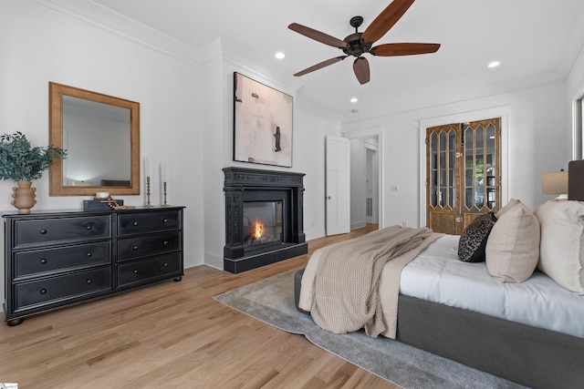 bedroom with recessed lighting, ornamental molding, and light wood-type flooring
