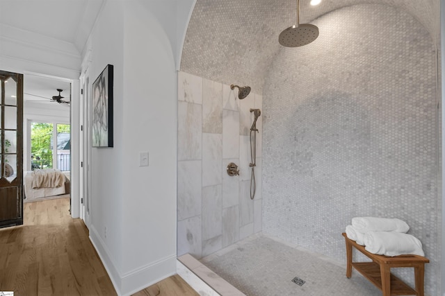 ensuite bathroom featuring tiled shower, ensuite bathroom, baseboards, wood finished floors, and ceiling fan