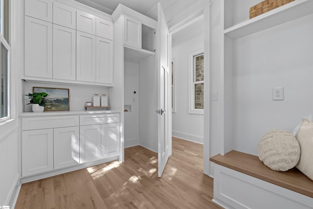 mudroom featuring light wood-style floors and baseboards