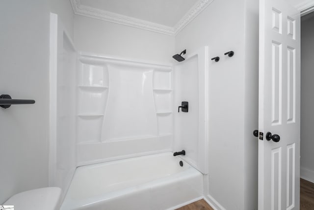full bathroom featuring toilet, ornamental molding, wood finished floors, and shower / bathing tub combination