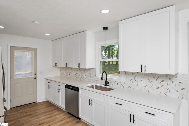 kitchen with recessed lighting, stainless steel appliances, light countertops, and a sink