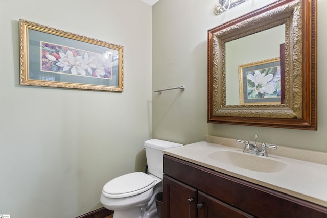 bathroom with toilet and vanity