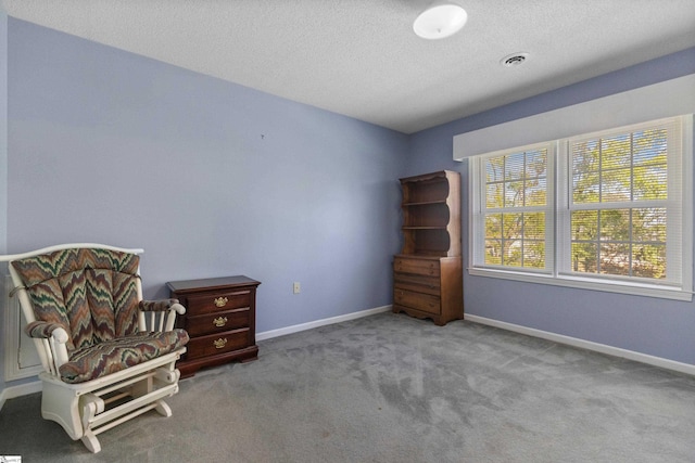 sitting room featuring a textured ceiling, carpet, visible vents, and baseboards