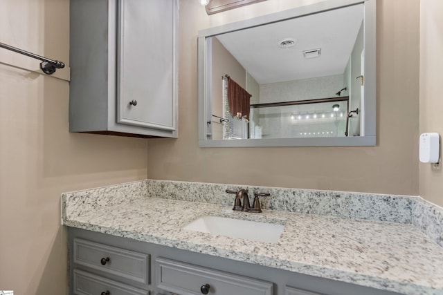 full bathroom with a shower, vanity, and visible vents