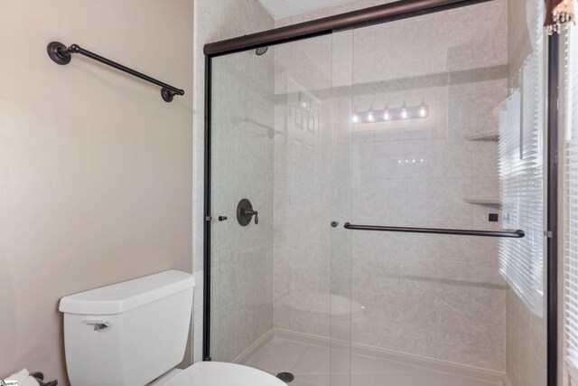 full bath with a shower stall and toilet