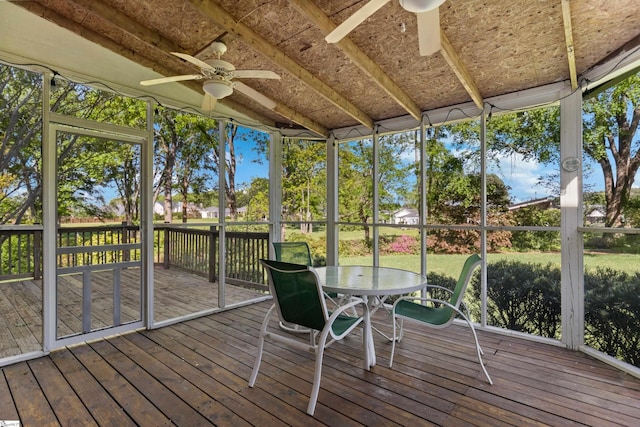 sunroom / solarium with outdoor dining area and ceiling fan