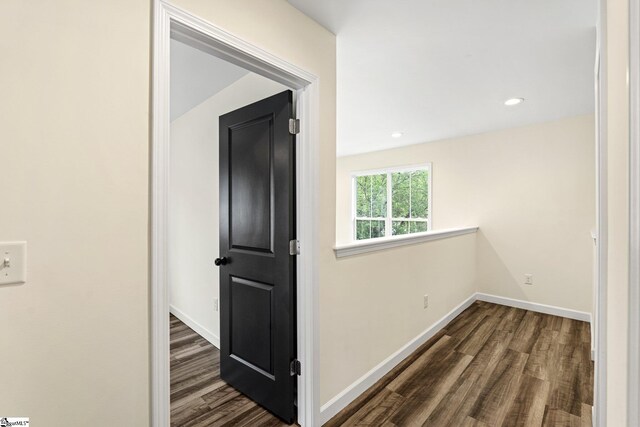 corridor featuring dark wood finished floors, baseboards, and recessed lighting