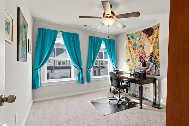 carpeted home office featuring ceiling fan, baseboards, and visible vents