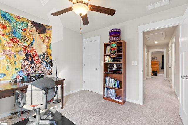 office with attic access, visible vents, carpet flooring, and a ceiling fan