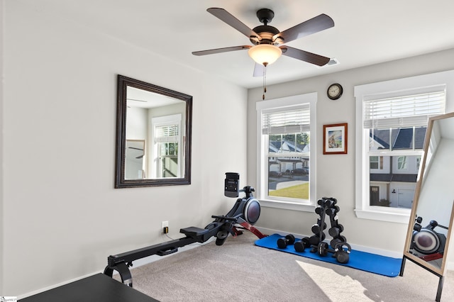exercise room featuring carpet floors, baseboards, and ceiling fan