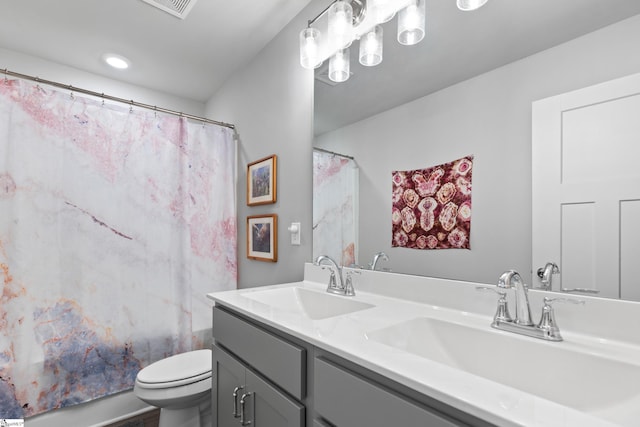 full bath featuring shower / tub combo, a sink, double vanity, and toilet