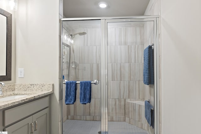 bathroom featuring recessed lighting, vanity, and a stall shower