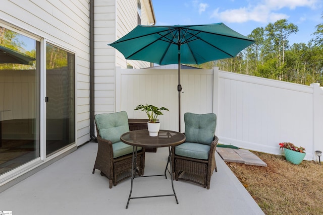 view of patio with outdoor dining space and a fenced backyard