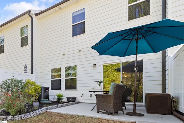 back of property with a patio area, central AC, and fence