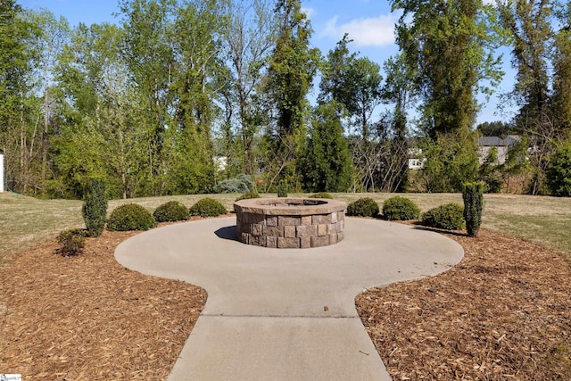view of property's community with a fire pit and a patio area