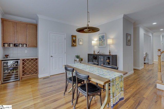 102 Beckworth Dr, Taylors, SC 29687 - dining space featuring wine cooler, baseboards, recessed lighting, light wood-style floors, and crown molding
