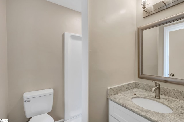 bathroom featuring toilet and vanity