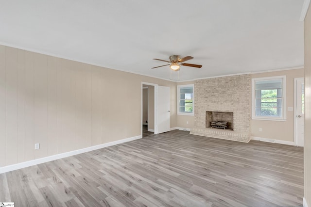unfurnished living room featuring plenty of natural light, wood finished floors, and ceiling fan