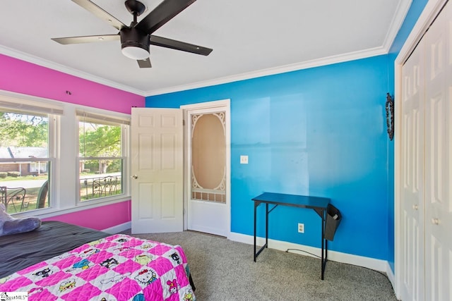 carpeted bedroom with baseboards, a closet, ceiling fan, and crown molding